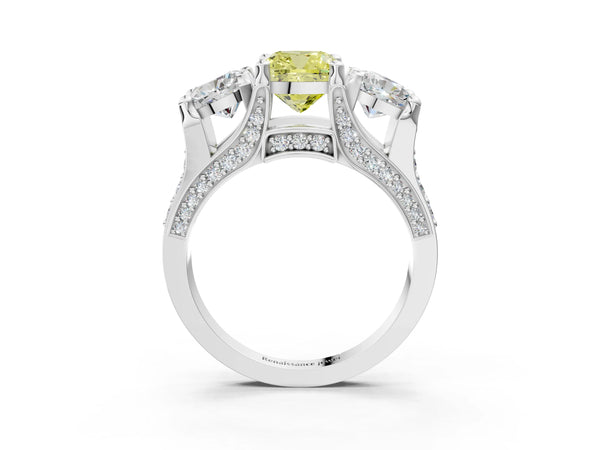 Platinum Fancy Yellow Cushion Cut Diamond Three-Stone Ring with Channel Set Band and Four-Prong Setting