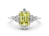 White gold Fancy Yellow Emerald Cut Brilliant Diamond with Cluster Setting on a Beaded Band and Four-Prong Setting