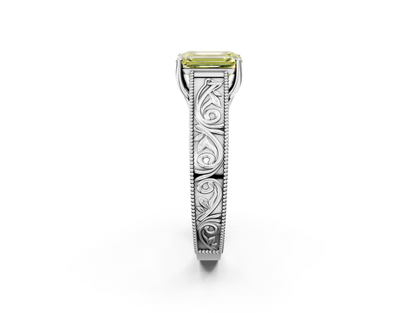 White gold Fancy Yellow Emerald Cut Diamond Solitaire Ring with Engraved Band and Four-Prong Setting