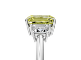 18K White Gold 5.03 Carat Yellow VVS2 Emerald Diamond Three-Stone Ring with Trapezoid Side Stones and Prong Setting