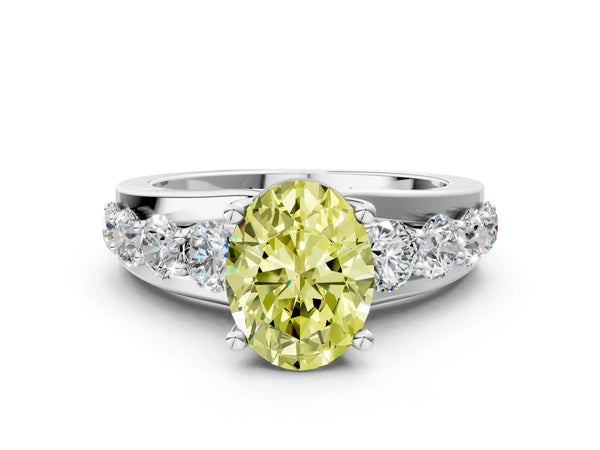 White gold Fancy Yellow Oval  Brilliant Solitaire with Side Stones on a Pave Band and Four-Prong Setting