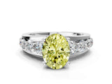 White gold Fancy Yellow Oval  Brilliant Solitaire with Side Stones on a Pave Band and Four-Prong Setting_61