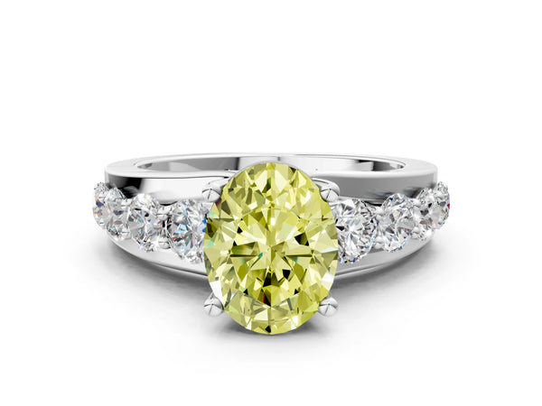 White gold Fancy Yellow Oval  Brilliant Solitaire with Side Stones on a Pave Band and Four-Prong Setting