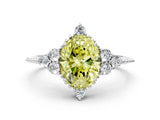 White gold Fancy Yellow Oval Cut Brilliant Diamond with Cluster Setting on a Beaded Band and Four-Prong Setting