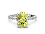 White gold Fancy Yellow Oval Cut Diamond Brilliant Solitaire Ring with Pavé Band and Four-Prong Setting