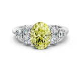 White gold Fancy Yellow Oval  Cut Diamond Cluster Ring with Round Accent Stones and Prong Setting on a Classic Band_49