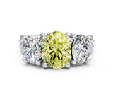 White gold Fancy Yellow Oval Cut Diamond Three-Stone Ring with Channel Set Band and Four-Prong Setting_77