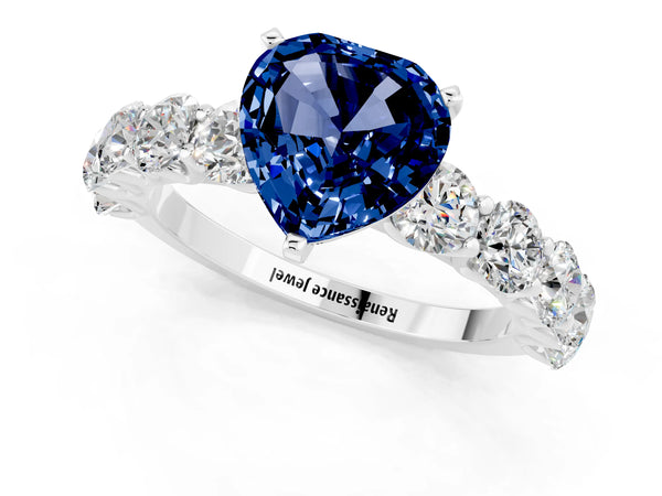 Platinum Heart Cut Blue Sapphire Prong Setting with Side Stones on a Pave Band