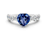 White gold Heart Cut Blue Sapphire Prong Setting with Side Stones on a Pave Band