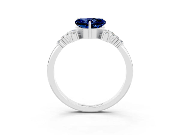 White gold Heart Cut Blue Sapphire Ring with Side Stones and Four-Prong Setting