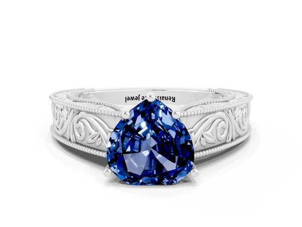 White gold Heart Cut Blue Sapphire Solitaire Ring with Engraved Band and Four-Prong Setting
