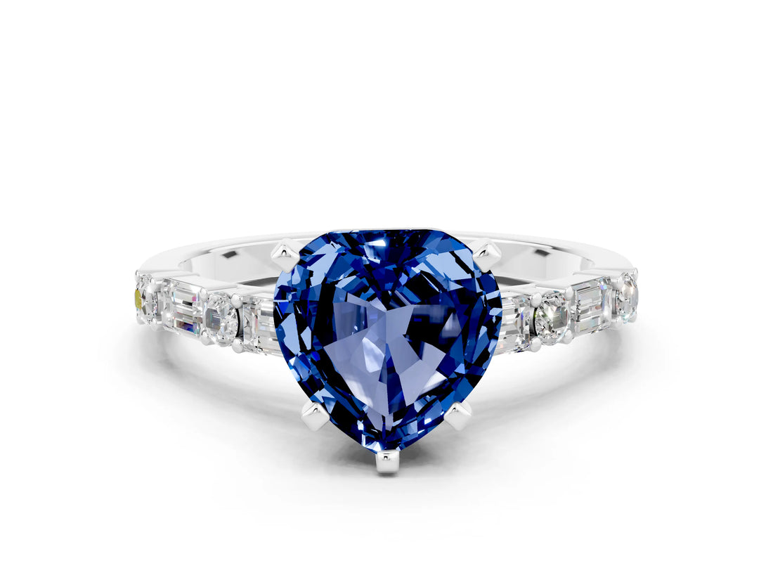 White gold Heart Cut Blue Sapphire Solitaire with Side Baguettes and Channel Set Band
