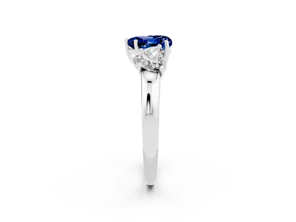 Platinum Heart Cut Blue Sapphire Three-Stone Ring with Four-Prong Setting and Classic Band