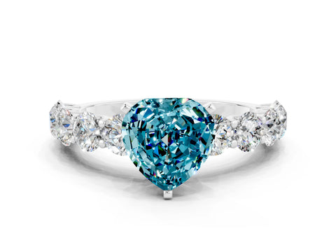 White gold Heart Cut Blue Topaz Prong Setting with Side Stones on a Pave Band
