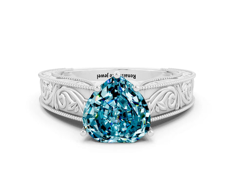 White gold Heart Cut Blue Topaz Solitaire Ring with Engraved Band and Four-Prong Setting