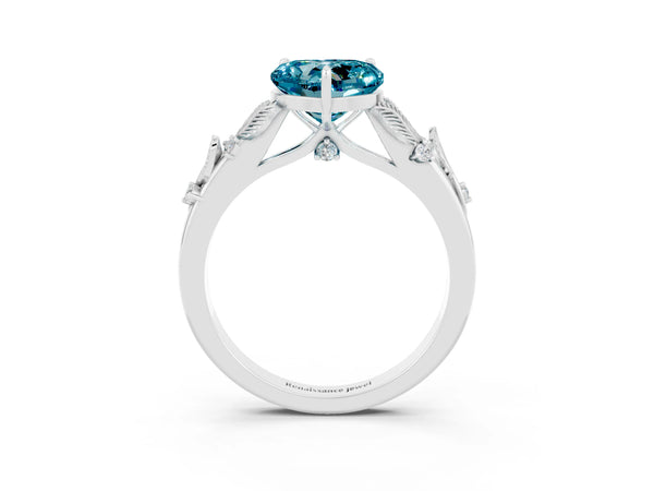 Platinum Heart Cut Blue Topaz Solitaire Ring with Leaf Motif Band and Four-Prong Setting