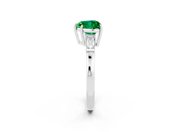 Platinum Heart Cut Emerald Three-Stone Ring with Tapered Baguette Side Stones and Prong Setting