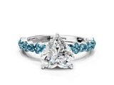 White gold Heart Cut Diamond Side Stone Solitaire Ring with Round with Blue Topaz side stone and Four-Prong Setting