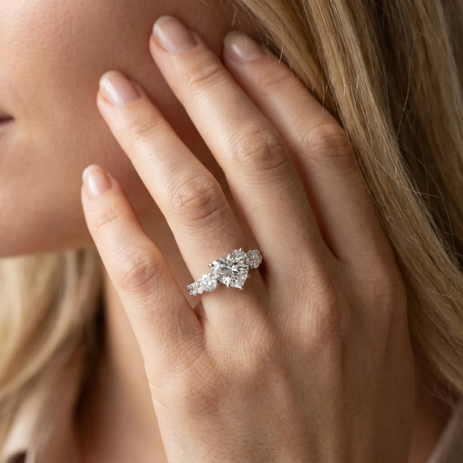 White gold Heart Cut Diamond Three-Stone Ring with Round Side Stones and Pavé Band