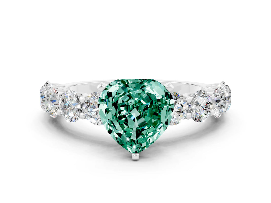 White gold Heart Cut Green Sapphire Prong Setting with Side Stones on a Pave Band