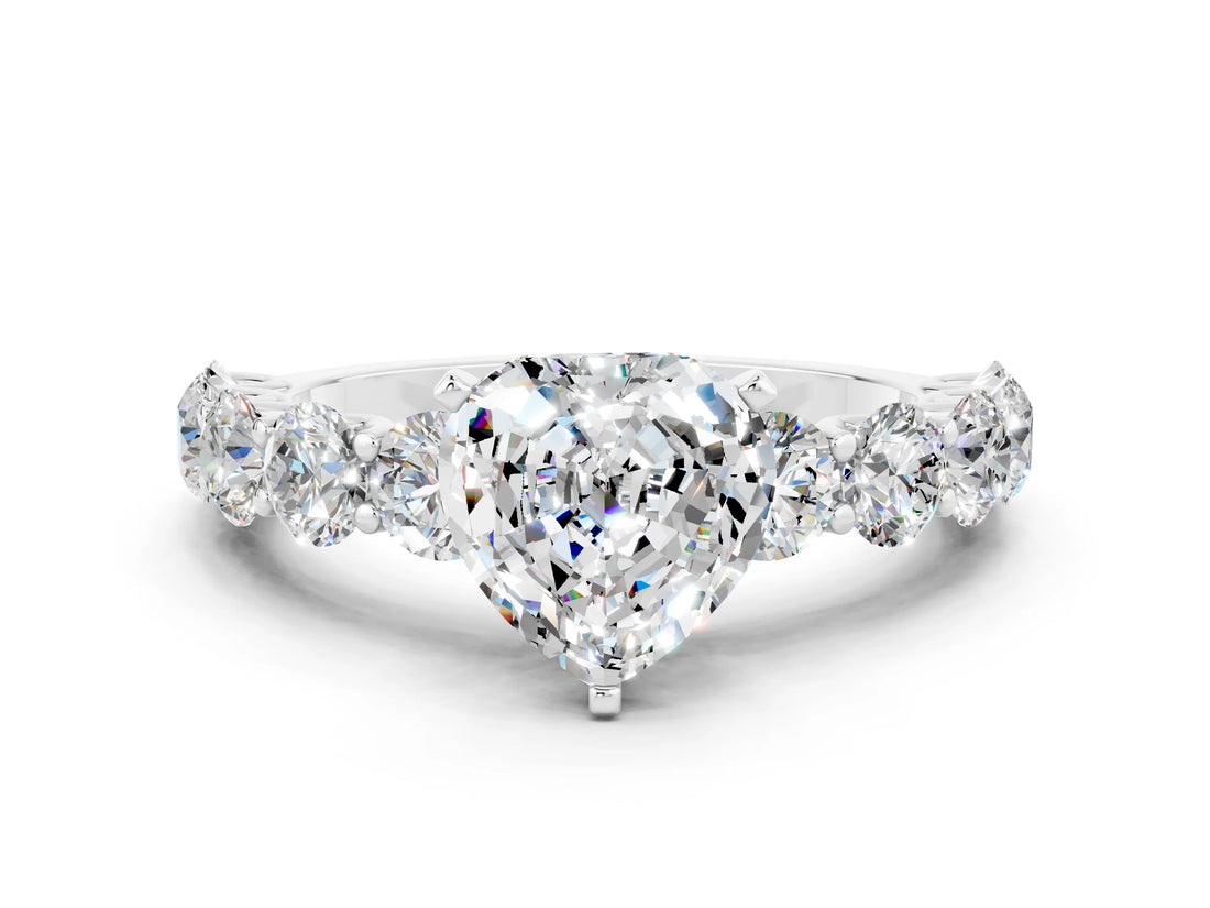 White gold Heart Cut Moissanite Prong Setting with Side Stones on a Pave Band