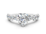 White gold Heart Cut Moissanite Prong Setting with Side Stones on a Pave Band