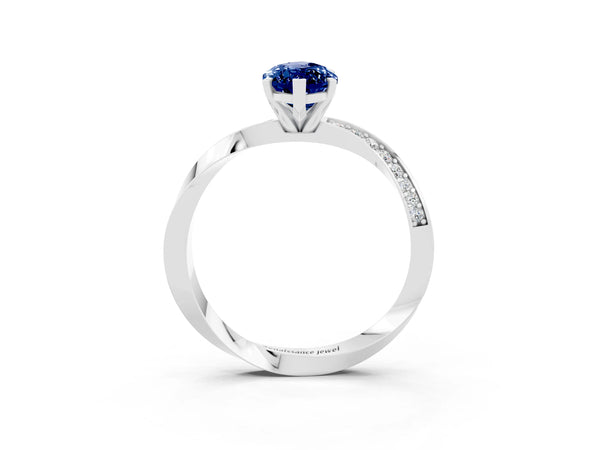 Silver Marquise Cut Blue Sapphire Engagement Ring with Side Stone Accents and Four-Prong Setting