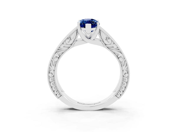 Platinum Marquise Cut Blue Sapphire Solitaire Ring with Engraved Band and Four-Prong Setting