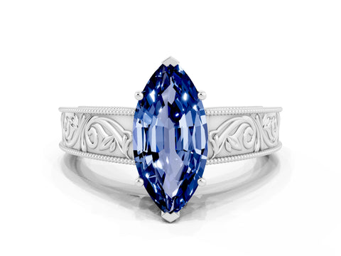 White gold Marquise Cut Blue Sapphire Solitaire Ring with Engraved Band and Four-Prong Setting