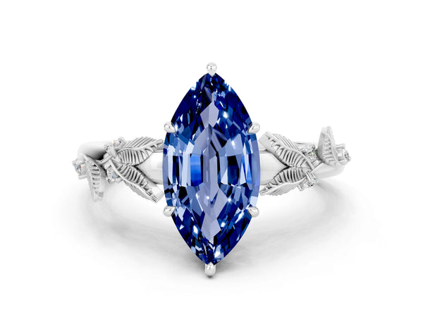 Platinum Marquise Cut Blue Sapphire Solitaire Ring with Leaf Motif Band and Four-Prong Setting
