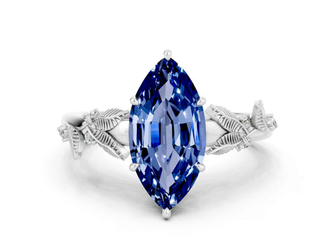 White gold Marquise Cut Blue Sapphire Solitaire Ring with Leaf Motif Band and Four-Prong Setting