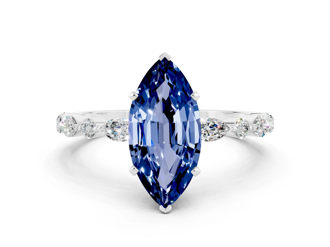 White gold Marquise Cut Blue Sapphire Solitaire with Side Stones on a Pavé Band and Four-Prong Setting
