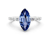 White gold Marquise Cut Blue Sapphire Solitaire with Side Stones on a Pavé Band and Four-Prong Setting