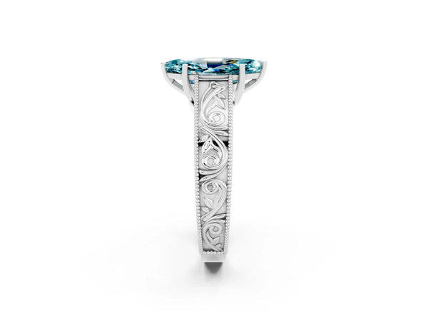 Silver Marquise Cut Blue Topaz Solitaire Ring with Engraved Band and Four-Prong Setting