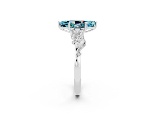 Platinum Marquise Cut Blue Topaz Solitaire Ring with Leaf Motif Band and Four-Prong Setting