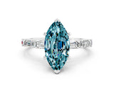 White gold Marquise Cut Blue Topaz Solitaire with Side Baguettes and Channel Set Band