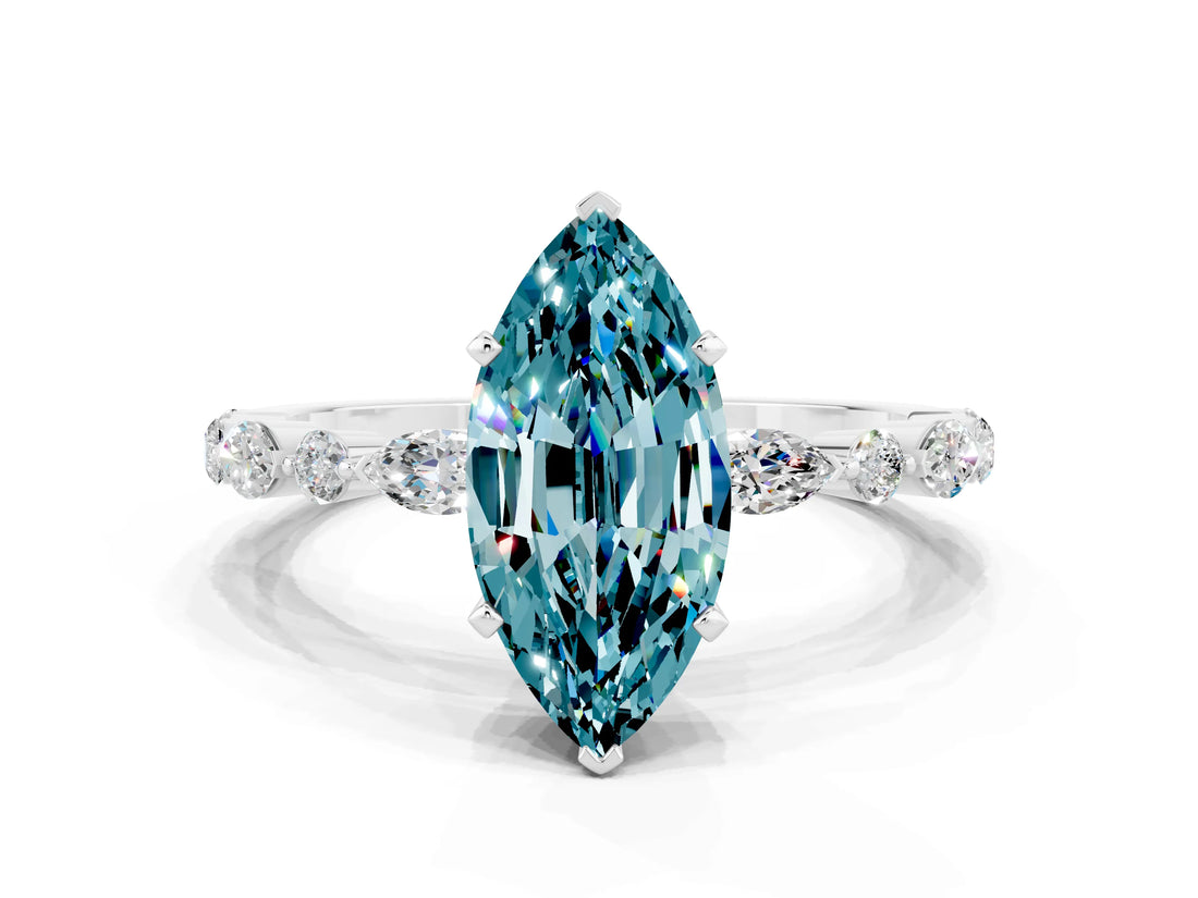 White gold Marquise Cut Blue Topaz Solitaire with Side Stones on a Pavé Band and Four-Prong Setting