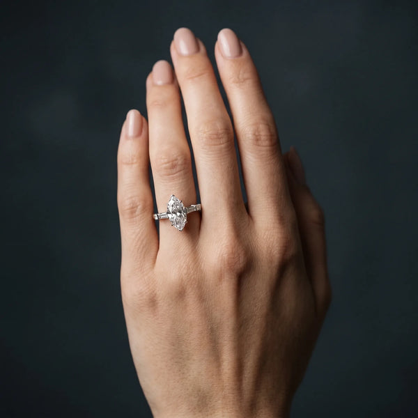 White gold Marquise Cut Diamond Ring with Baguette Side Stones, Channel Set Band, and Four-Prong Setting