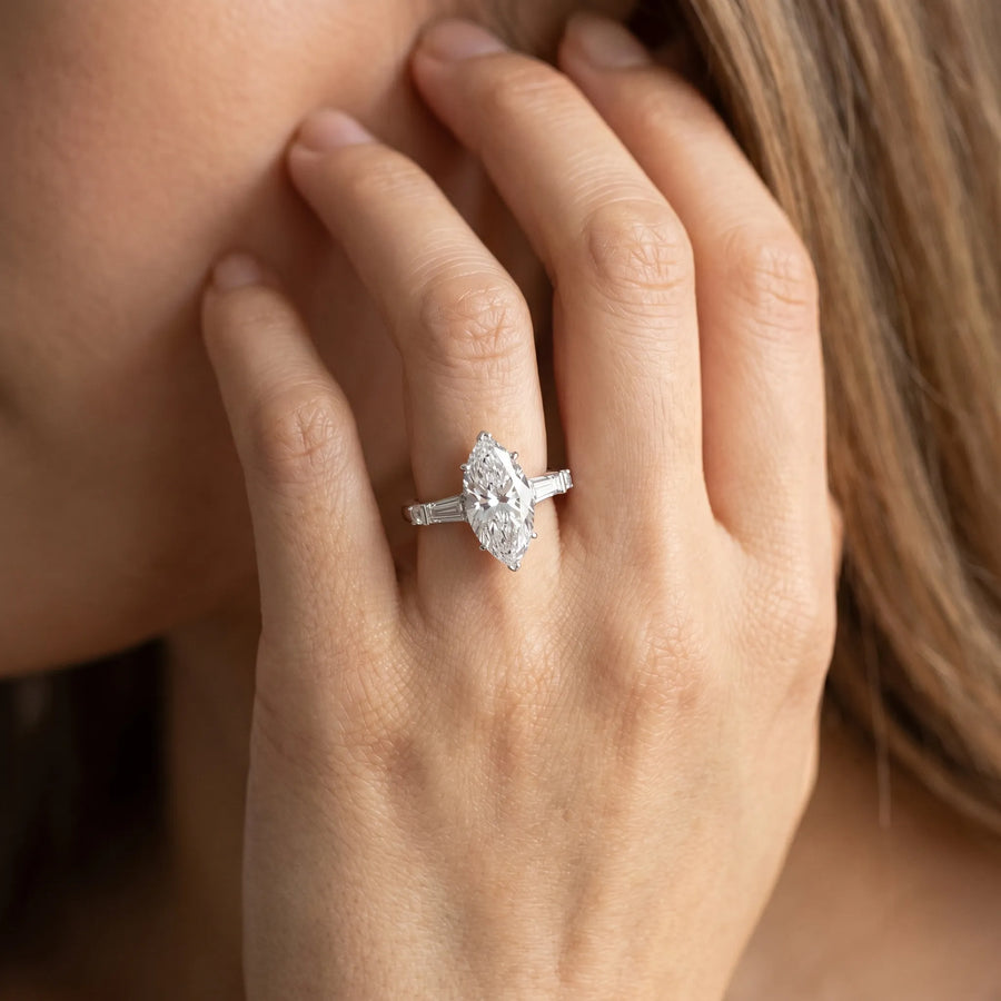 White gold Marquise Cut Diamond Ring with Baguette Side Stones, Channel Set Band, and Four-Prong Setting