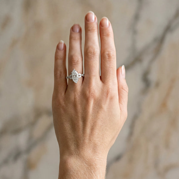 White gold Marquise Cut Diamond Solitaire Ring with Side Stones and Four-Prong Setting
