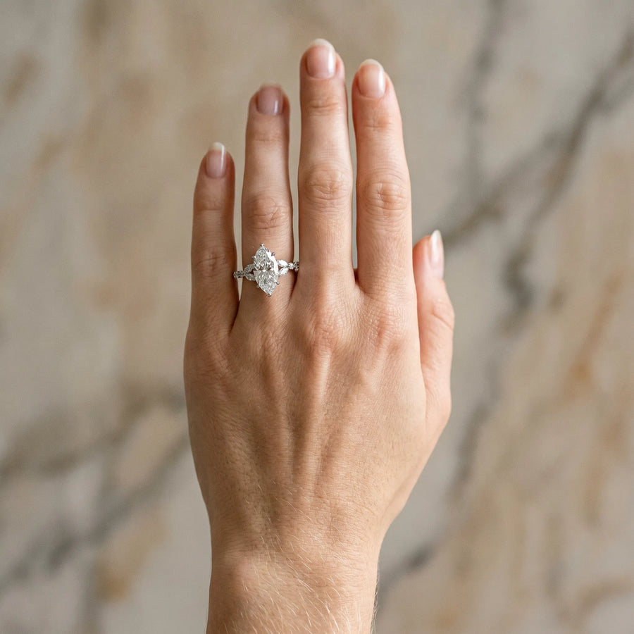 White gold Marquise Cut Diamond Solitaire Ring with Side Stones and Four-Prong Setting