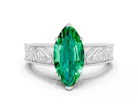 White gold Marquise Cut Emerald Solitaire Ring with Engraved Band and Four-Prong Setting