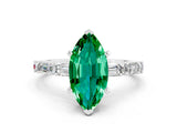 White gold Marquise Cut Emerald Solitaire with Side Baguettes and Channel Set Band