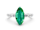 White gold Marquise Cut Emerald Solitaire with Side Stones on a Pavé Band and Four-Prong Setting