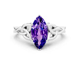 White gold Marquise Cut Tanzanite Solitaire Engagement Ring with Celtic Knot Band and Four-Prong Setting