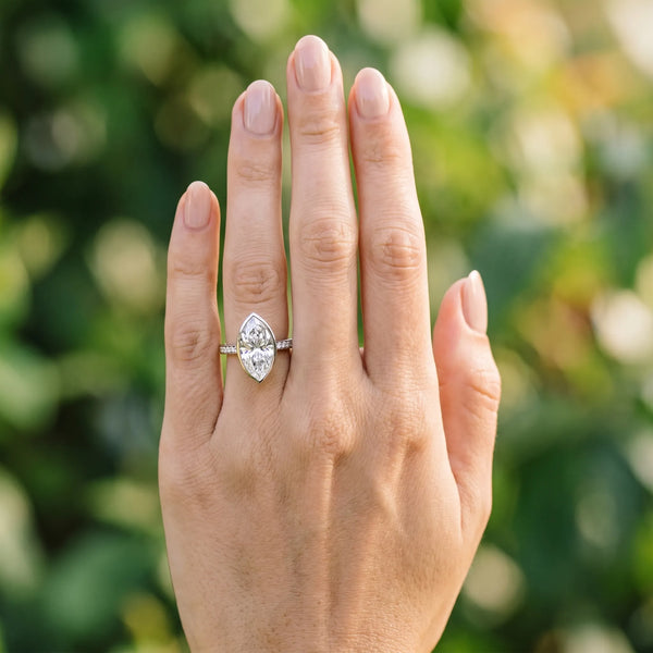 White gold Marquise Diamond Solitaire Ring with Bezel Setting and Classic Band