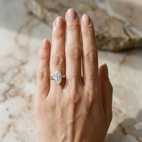 White gold Marquise Solitaire Diamond Ring with Channel-Set Baguette Band and Four-Prong Setting