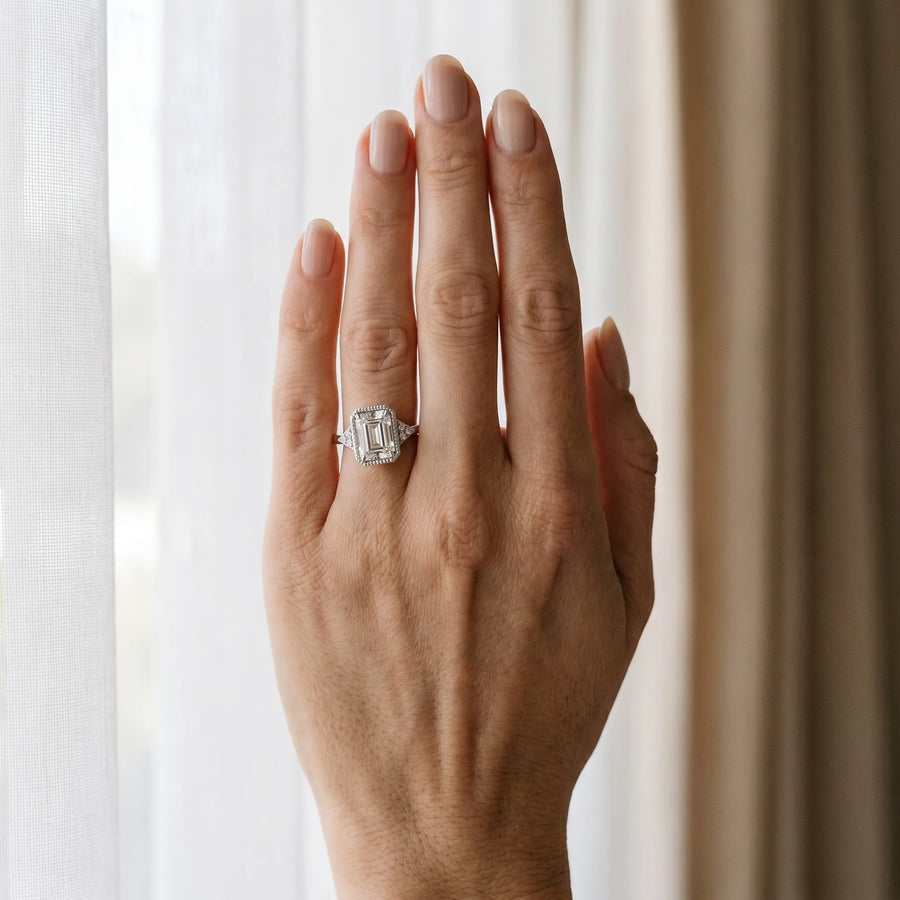 White gold Milgrain Emerald Cut Diamond Ring with Tapered Pave Band and Four Prong Setting