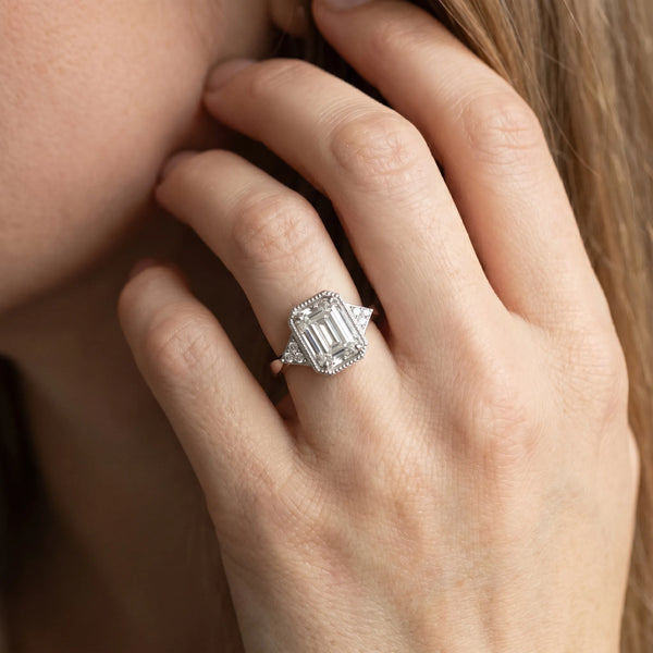 White gold Milgrain Emerald Cut Diamond Ring with Tapered Pave Band and Four Prong Setting