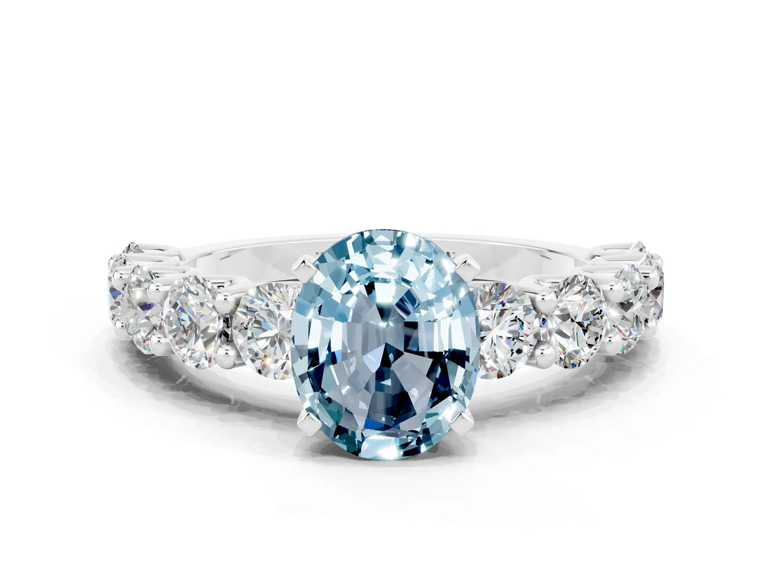 White gold Oval Cut Aquamarine Prong Setting with Side Stones on a Pave Band